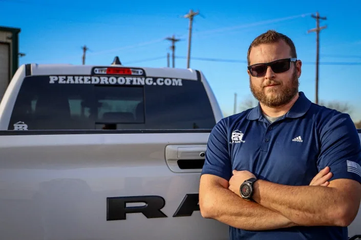 The Peaked team beside a company vehicle